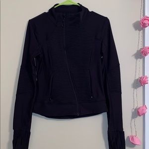 Black activewear jacket with curved zipper